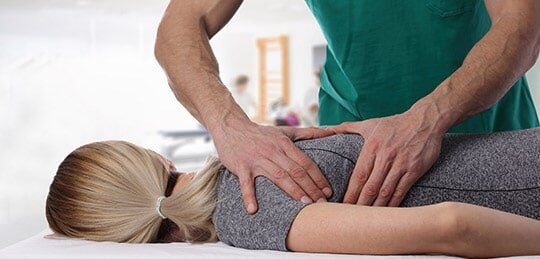 Woman Having Chiropractic Back Adjustment — Chiropractic in Maryville, TN