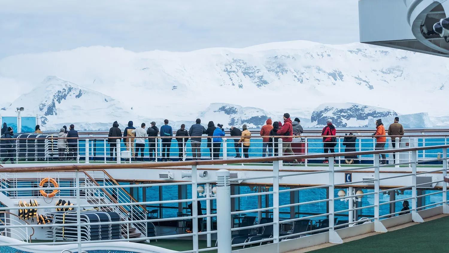 A group of people is looking over the Antarctic landscape.