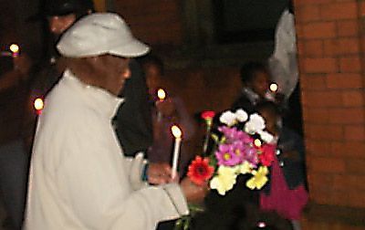 Mikey Powell's mother lays flowers