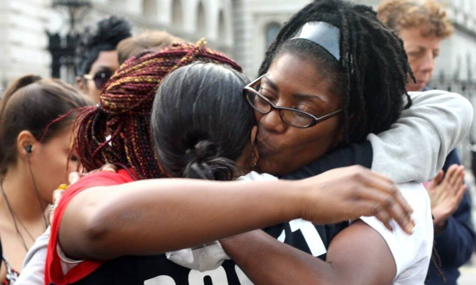Families comfort each other at a rally