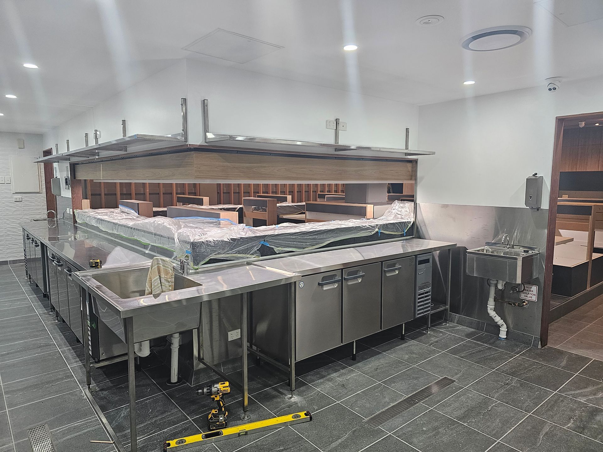 A large kitchen with a lot of stainless steel appliances and sinks.