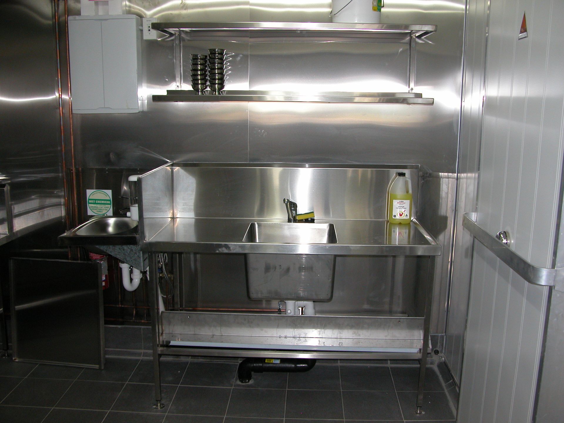 A kitchen with stainless steel appliances and a sink.