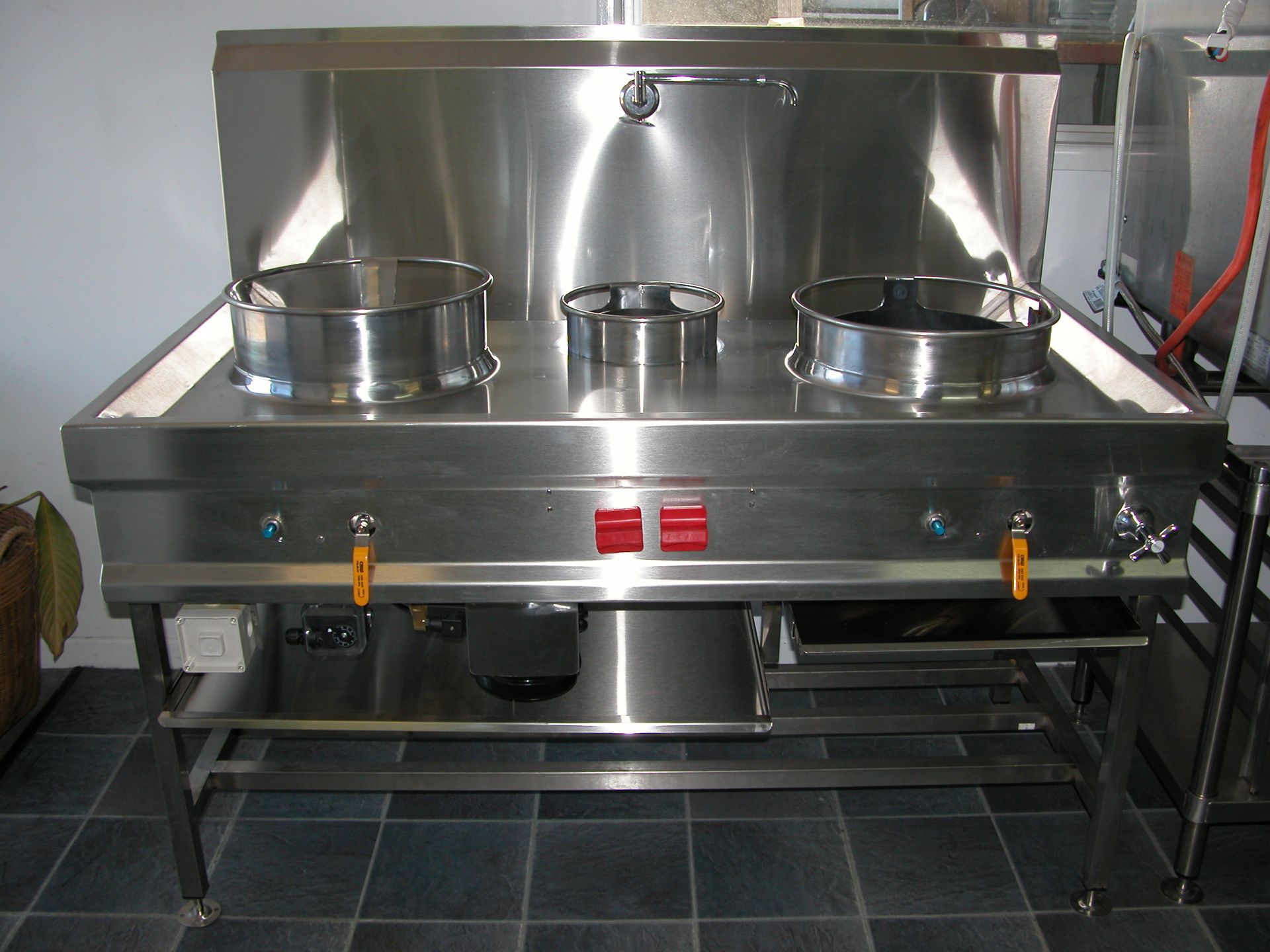 A stainless steel stove with two pots on it