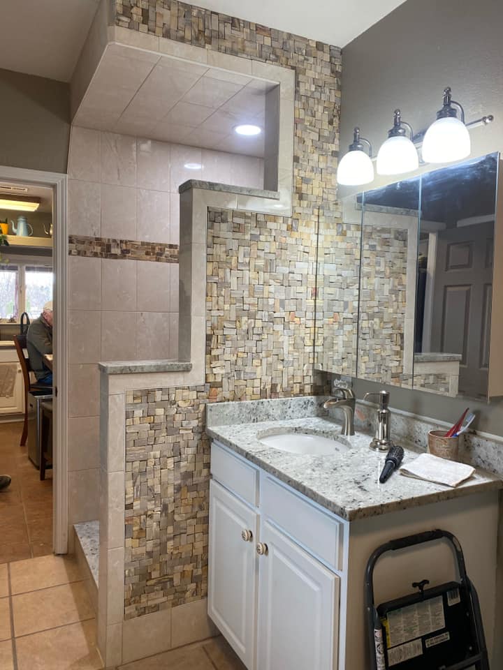 Full bathroom remodeling with ceramic and stone walls, ceramic tile floor, and custom stone inlay