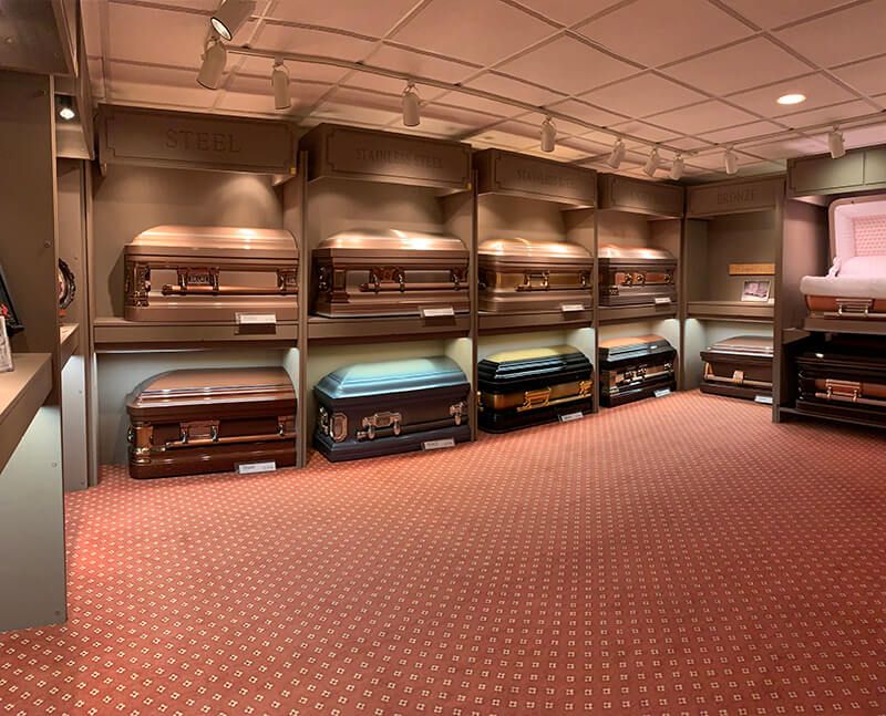 A room filled with lots of coffins on display