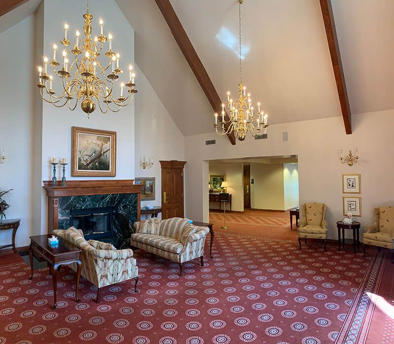 A living room with a fireplace couch and chairs