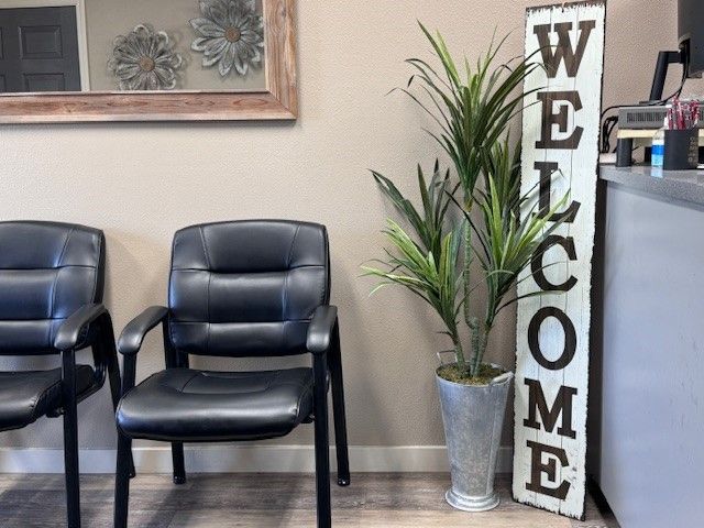 A waiting room with two chairs and a welcome sign