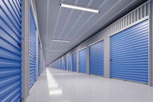 A long hallway filled with rows of blue storage units.