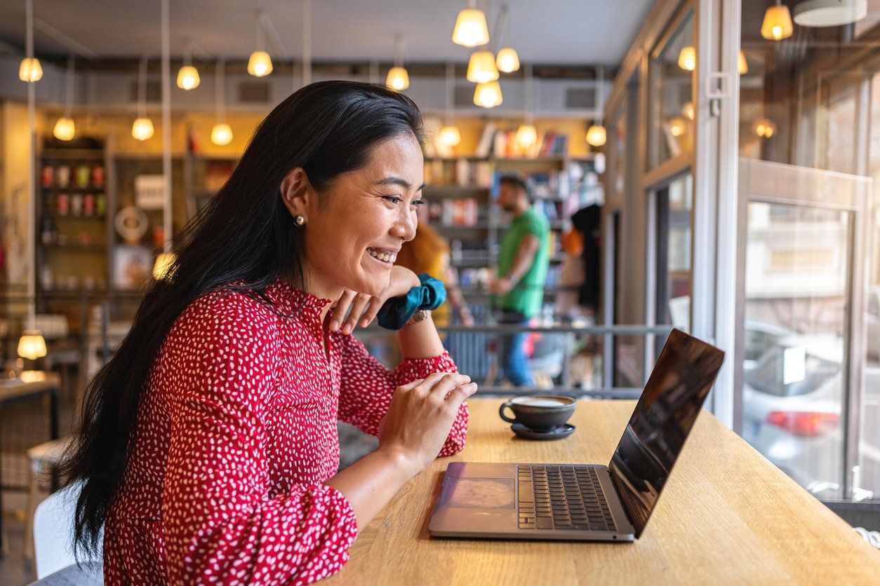 Smiling woman filing taxes in Texas coffee shop