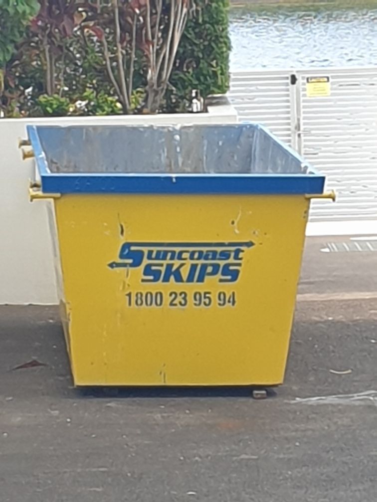 A small empty yellow skio bin — Suncoast Skips in Coolum Beach, QLD