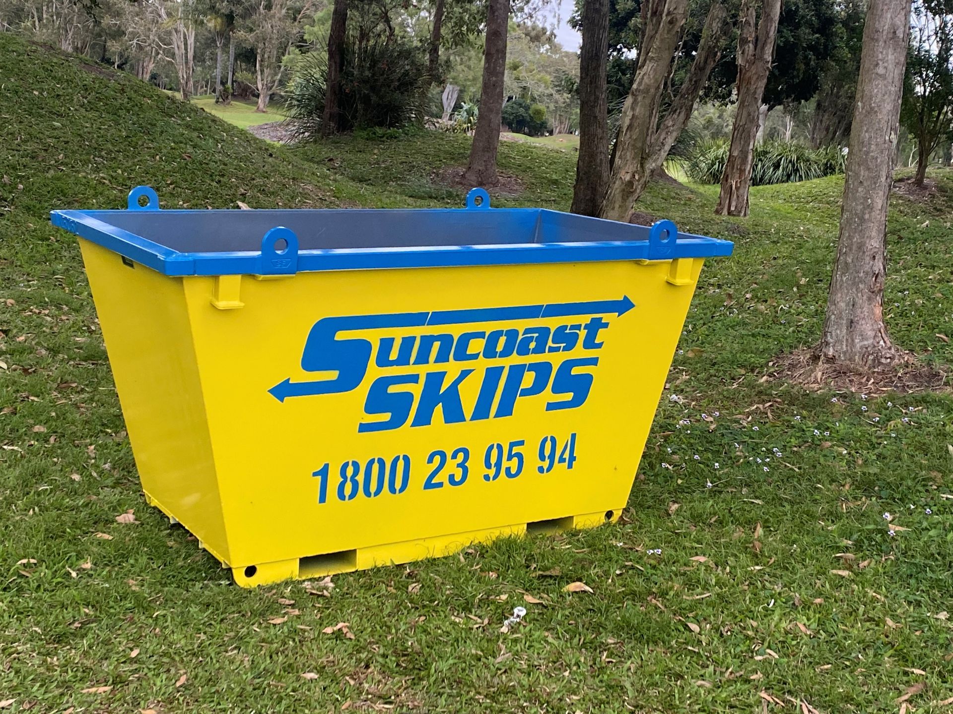 A yellow smaller sip bin sitting on the grass — Suncoast Skips in Coolum Beach, QLD
