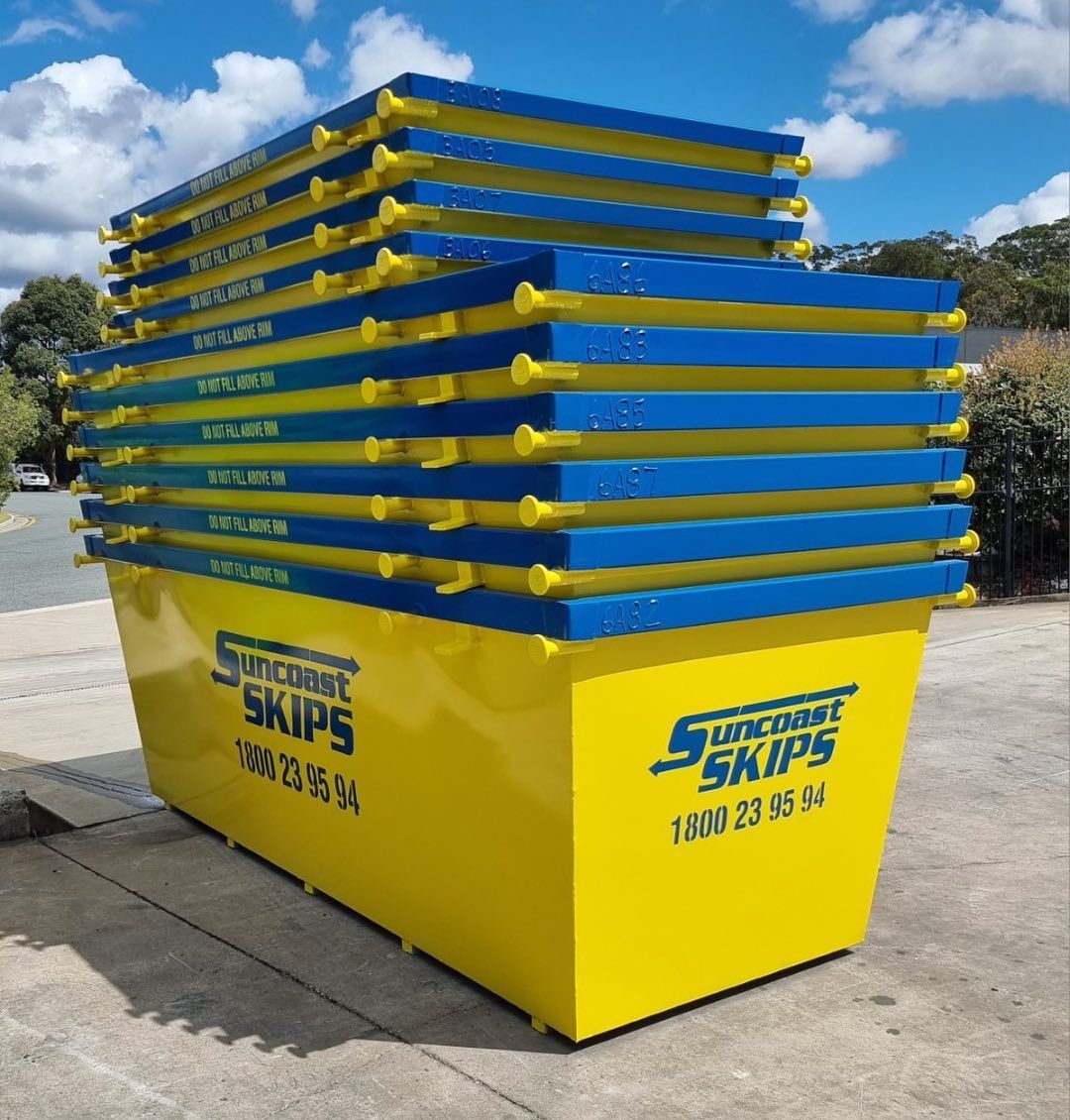 A Stack of Yellow and Blue skip bin From Suncoast Skips — Suncoast Skips in Coolum Beach, QLD