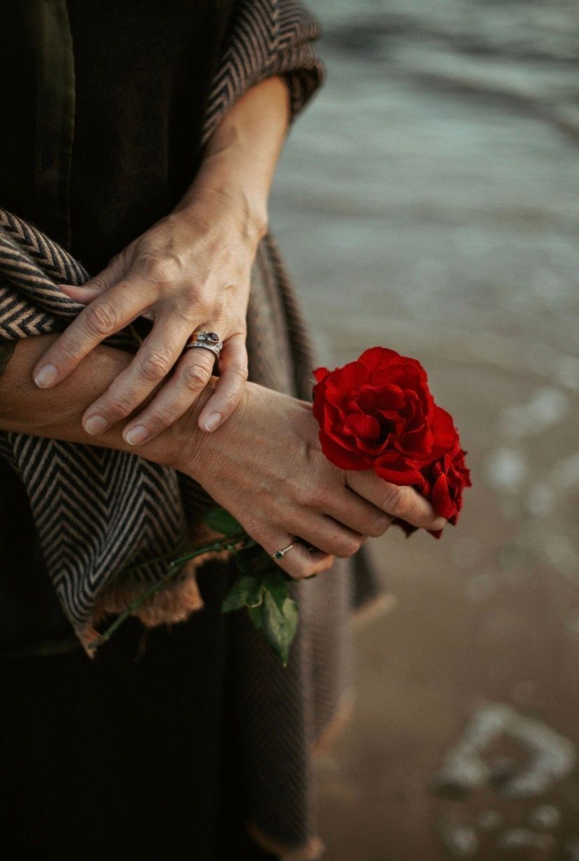 A person with long dark hair looks out over a calm mountain lake — Vedic Meditation & Coherence Personal Counselling in Coffs Harbour, NSW