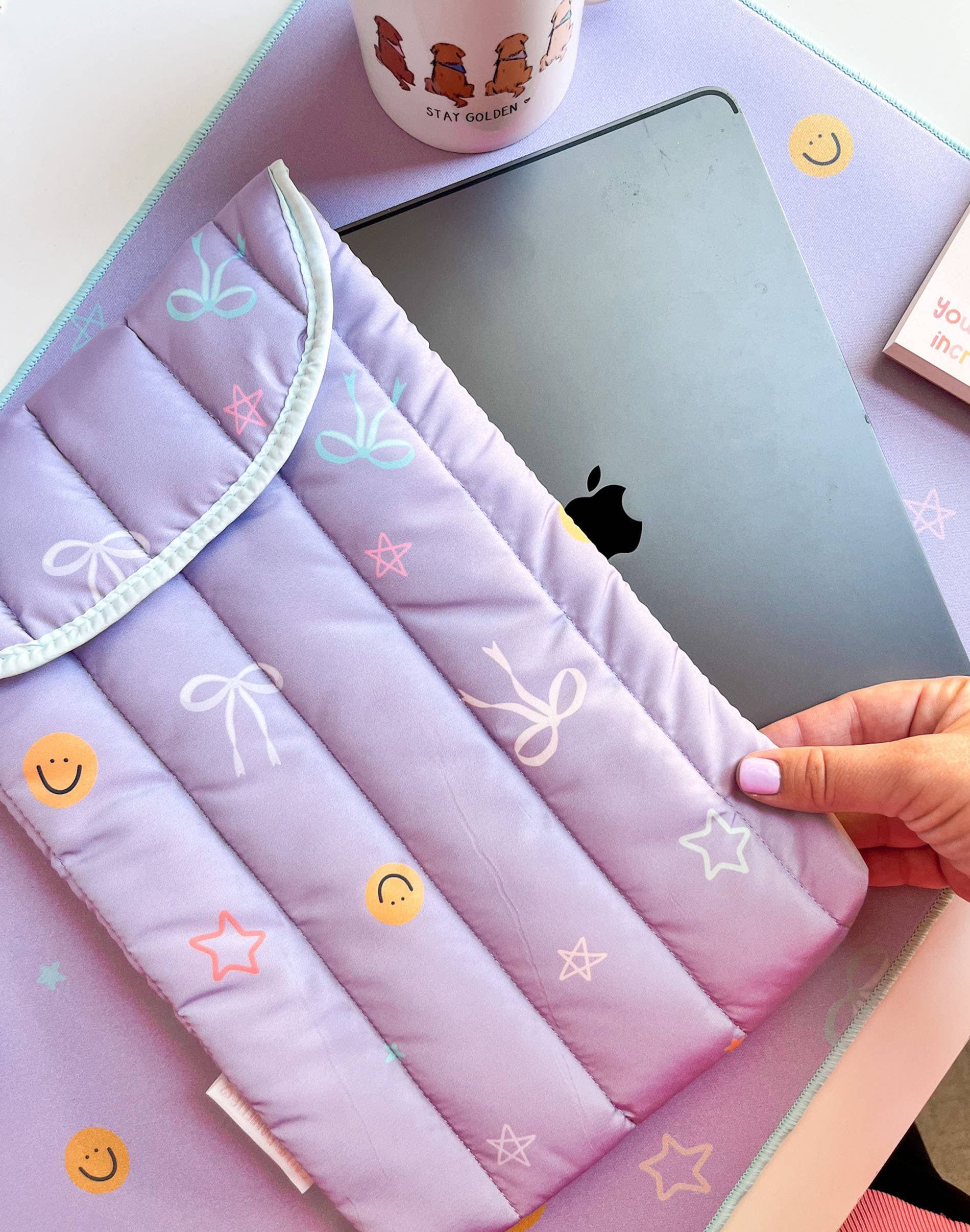 A person is holding a purple case over an apple ipad