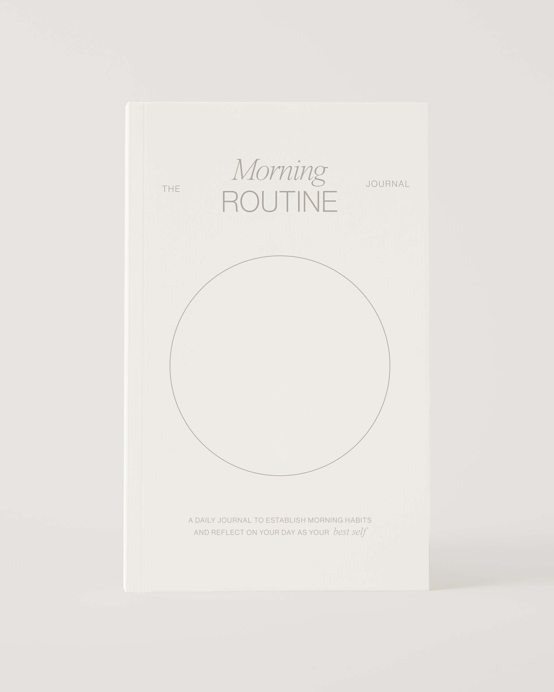 A white book with a circle on the cover is titled morning routine.