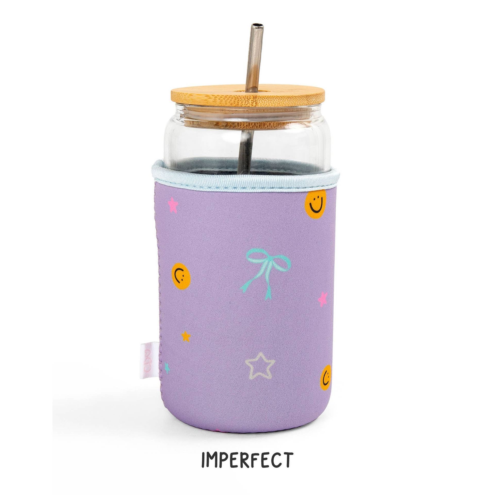 A glass jar with a straw and a purple sleeve that says imperfect
