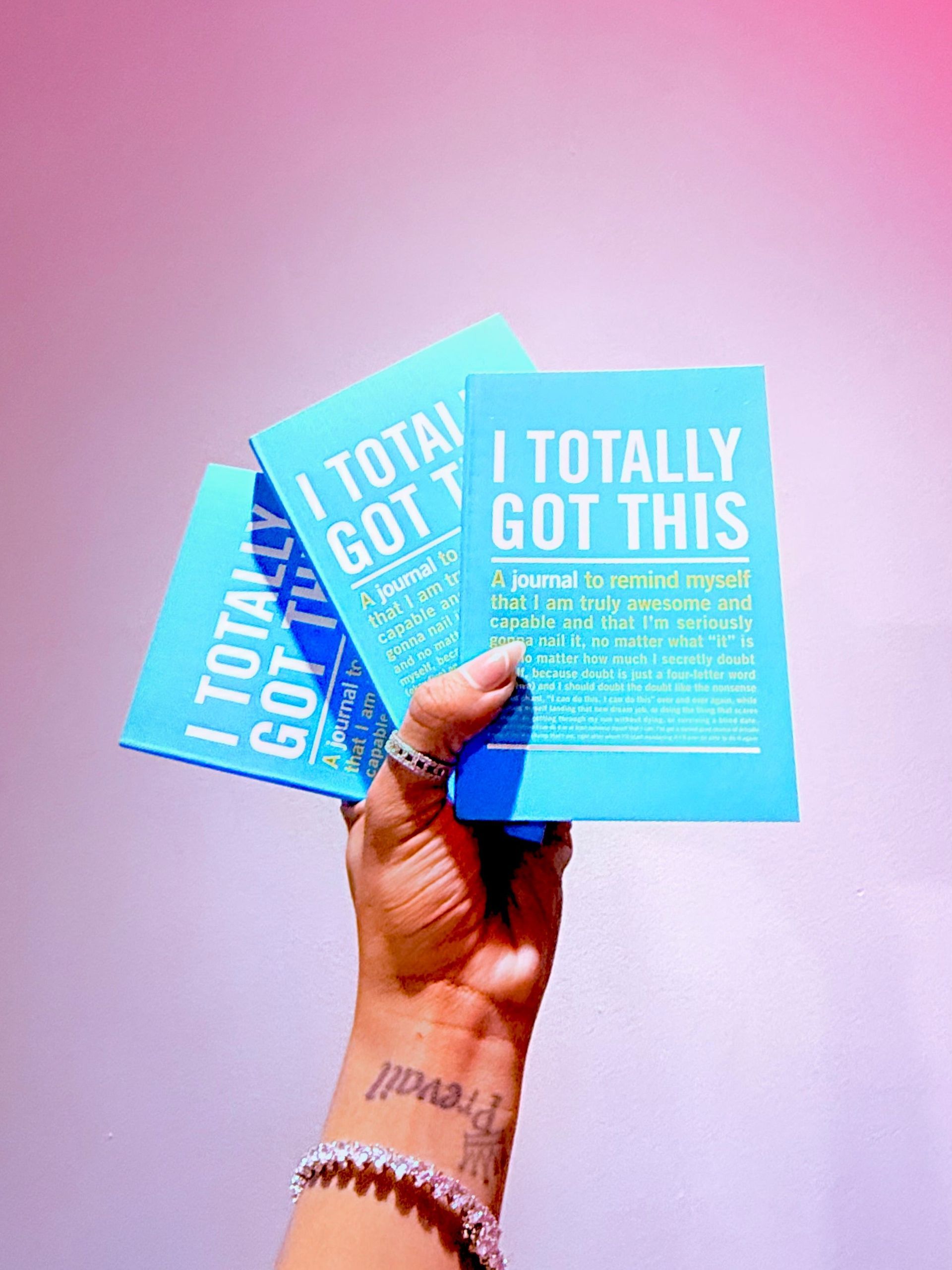 A person is holding three cards that say i totally got this