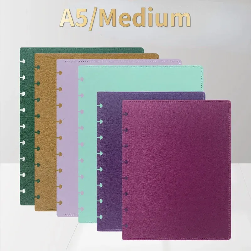A group of a5 / medium notebooks are stacked on top of each other