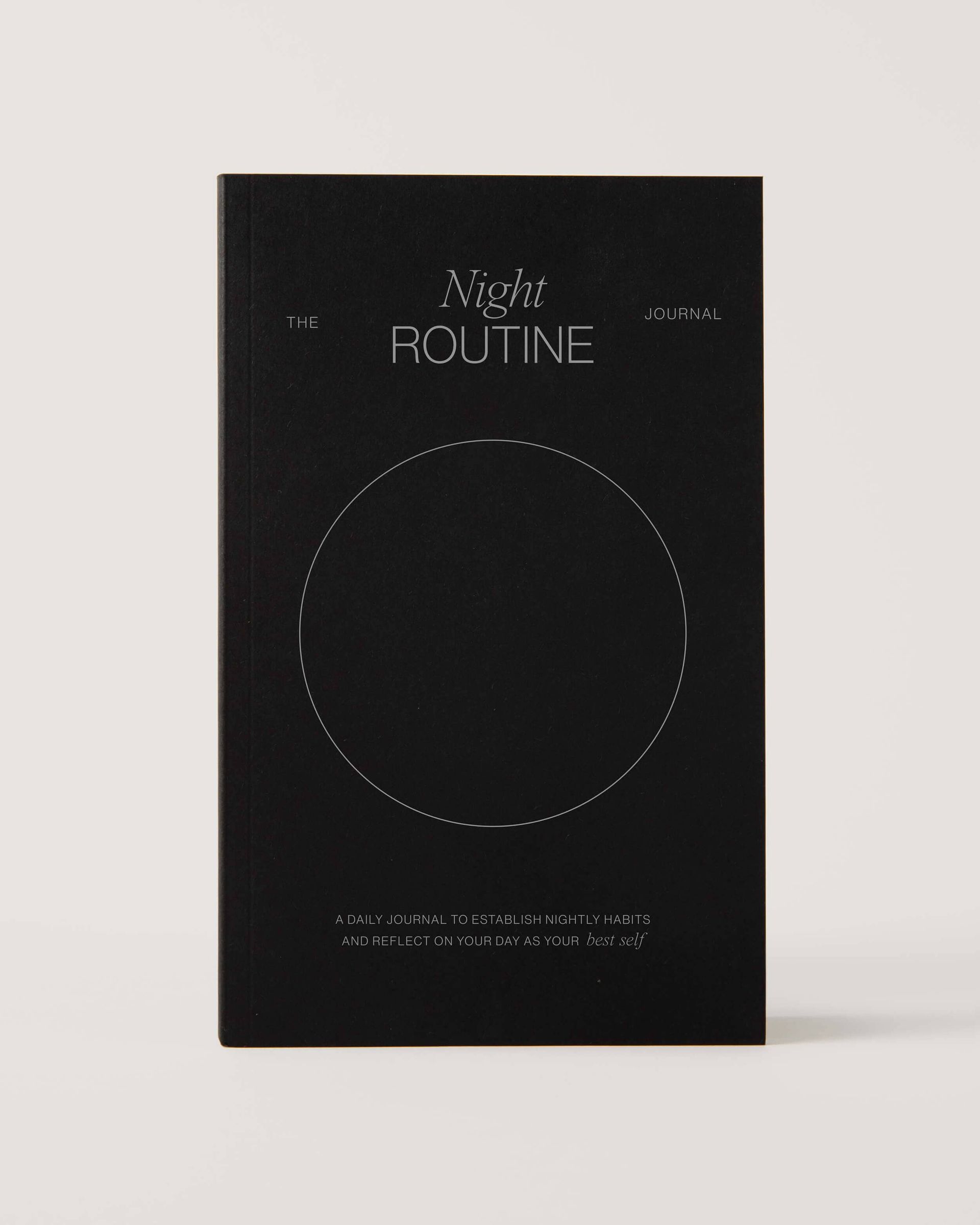 A black book titled night routine with a circle on the cover