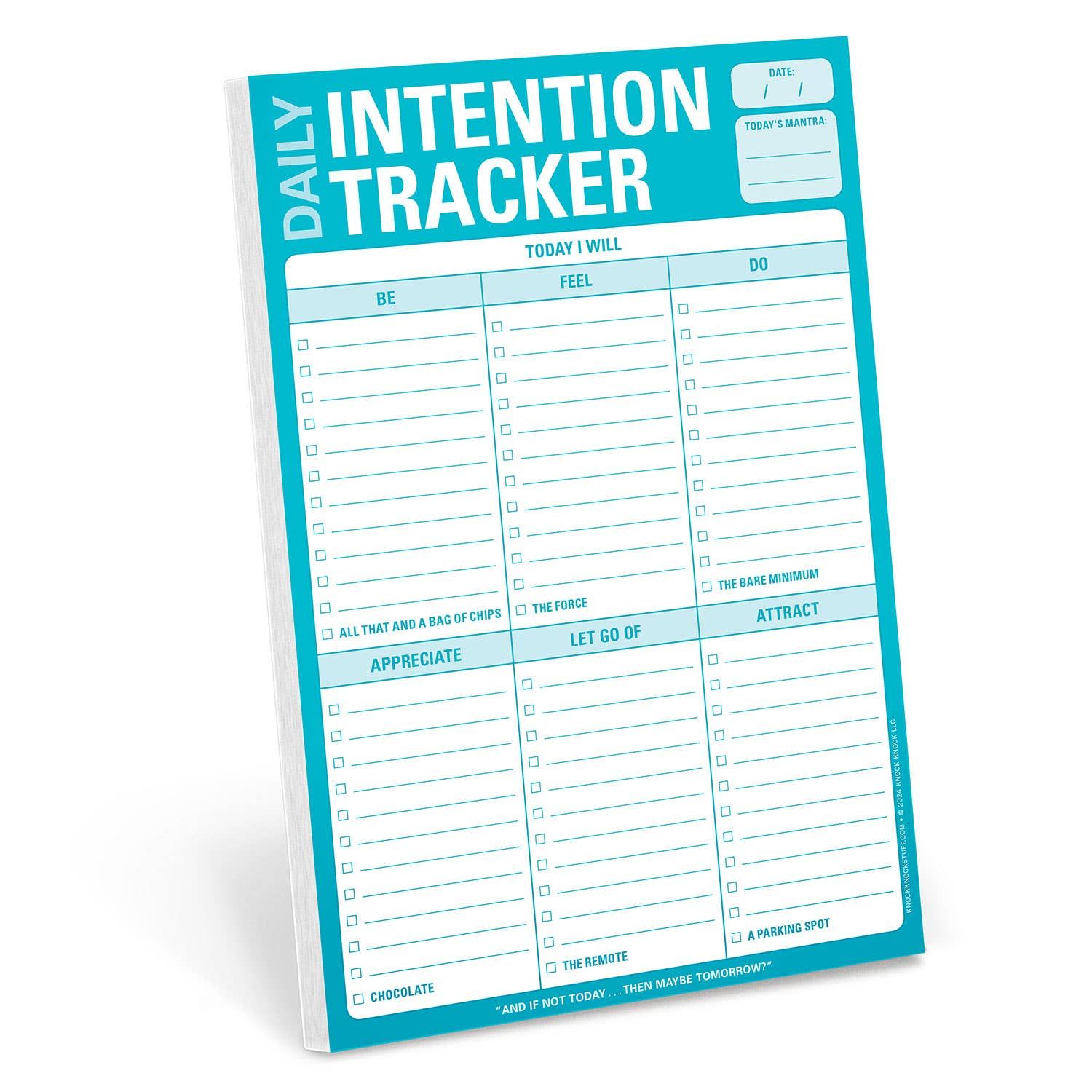 A blue daily intention tracker is sitting on a white surface