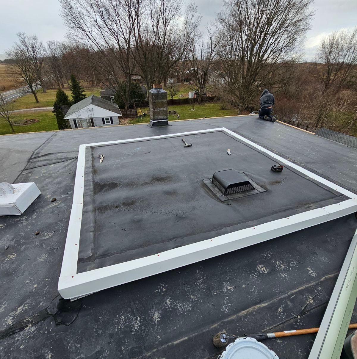 A man is working on the roof of a building.