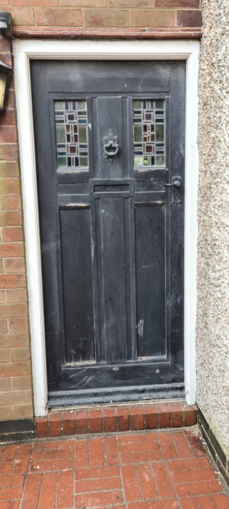 Old, worn door before replacement