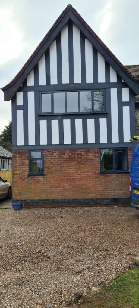 Long horizontal upstairs windows fitted into an old house