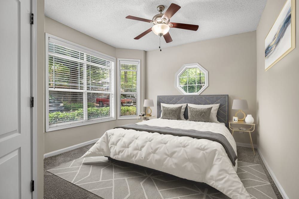 a bedroom with a large bed and a ceiling fan at Marquis Midtown West in Atlanta, GA.