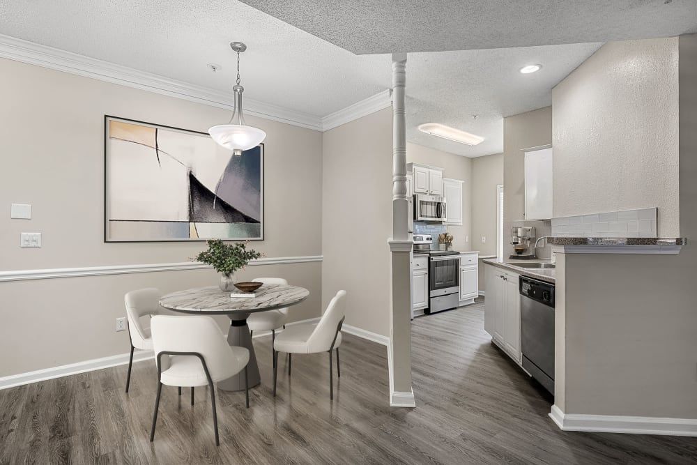 a dining room with a table and chairs next to a kitchen at Marquis Midtown West in Atlanta, GA.