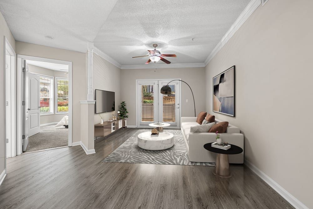 a living room with a couch , table , television and ceiling fan at Marquis Midtown West in Atlanta, GA.