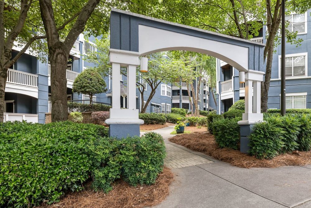 a blue and white building with a walkway leading to it at Marquis Midtown West in Atlanta, GA.