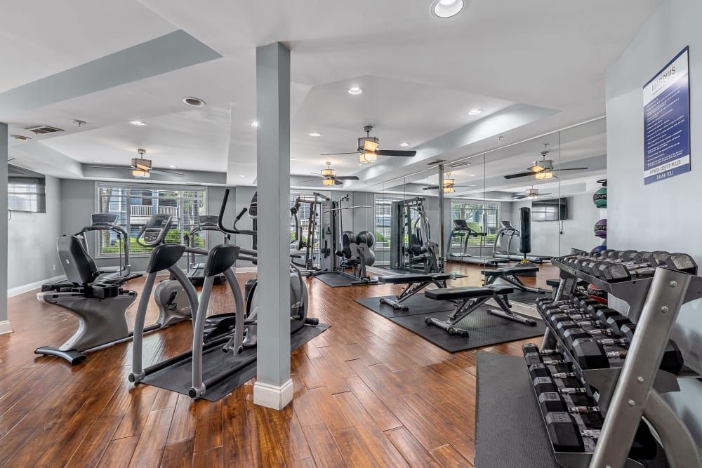 a large gym with a lot of equipment and a wooden floor at Marquis Midtown West in Atlanta, GA.