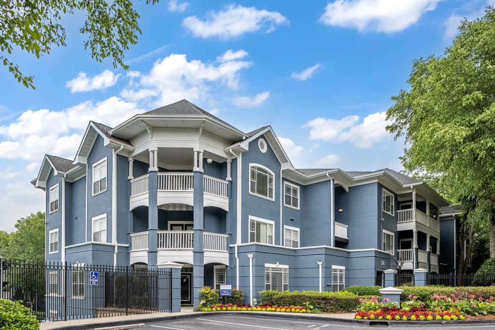 a large blue and white apartment building with a lot of windows and balconies at Marquis Midtown West in Atlanta, GA.