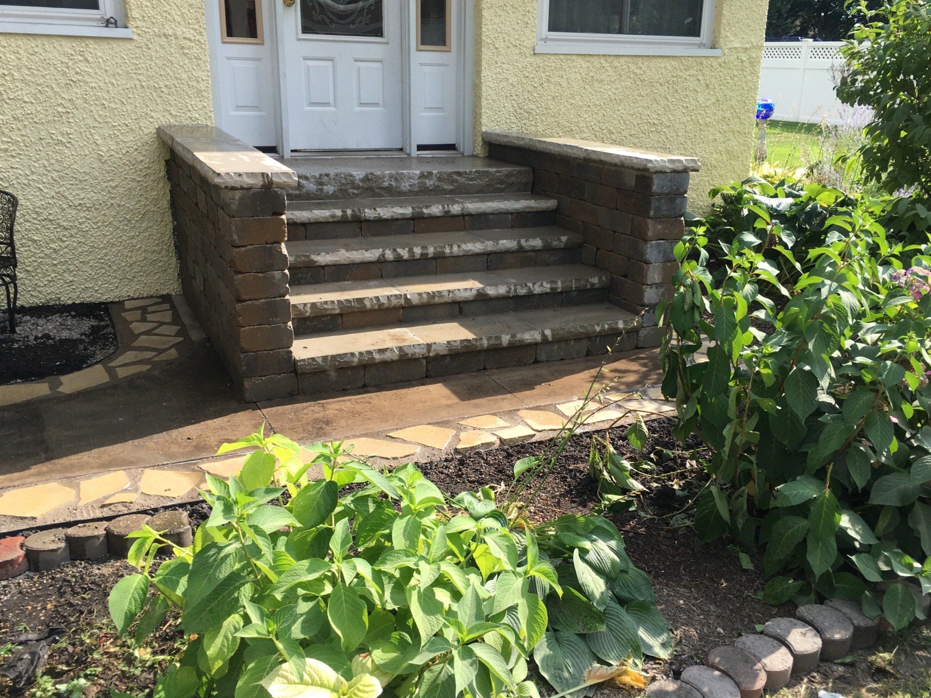 There are stairs leading up to the front door of a house.