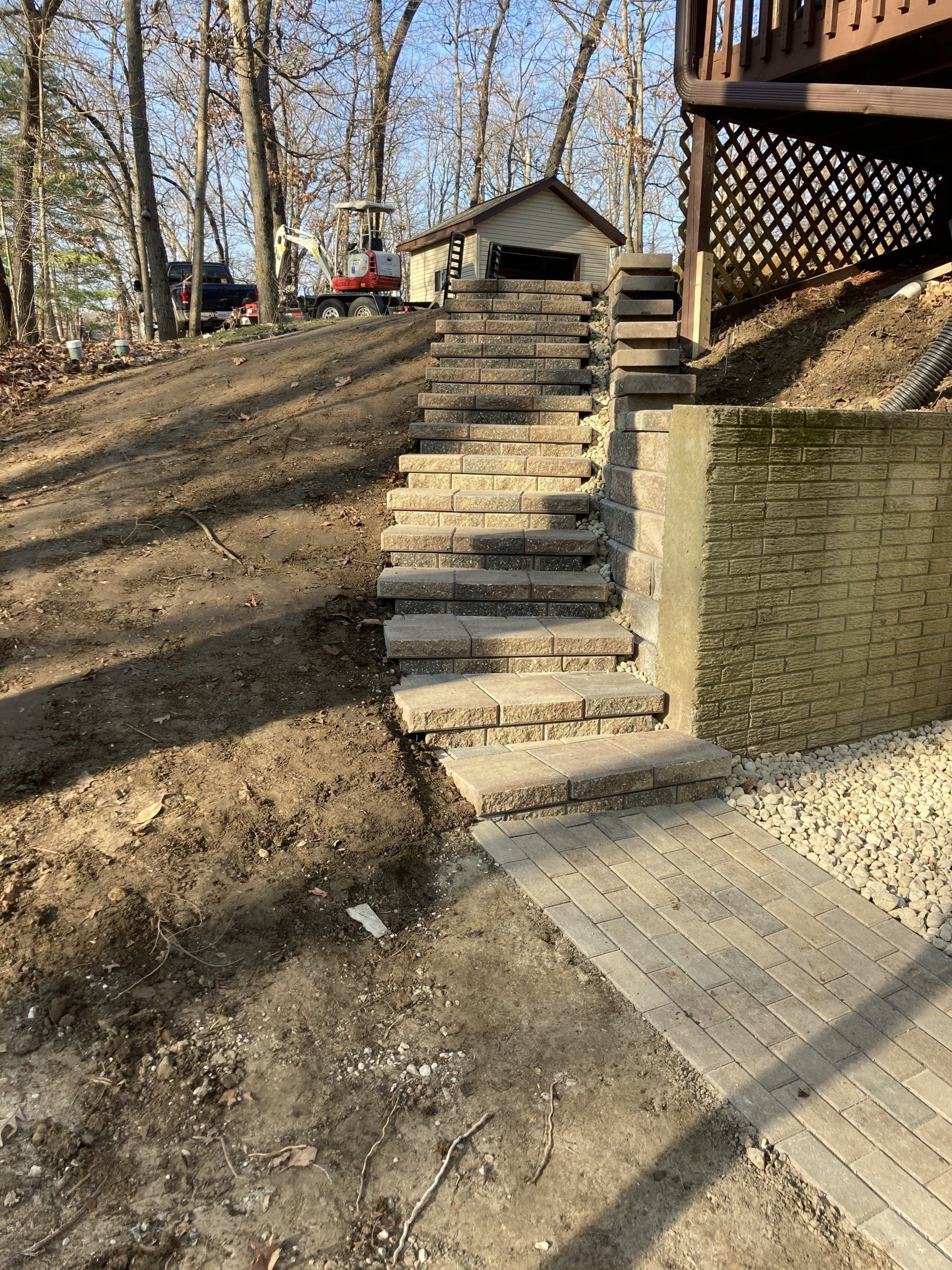 A set of stairs leading up to a house in the woods.