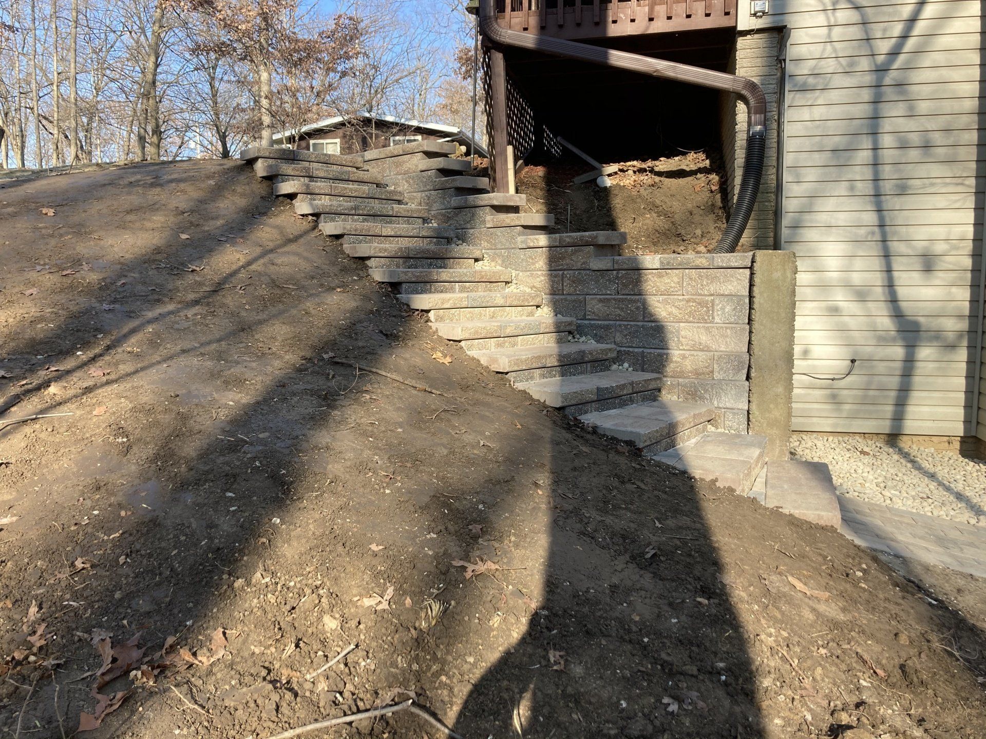 A set of stairs leading up to a house in the woods.
