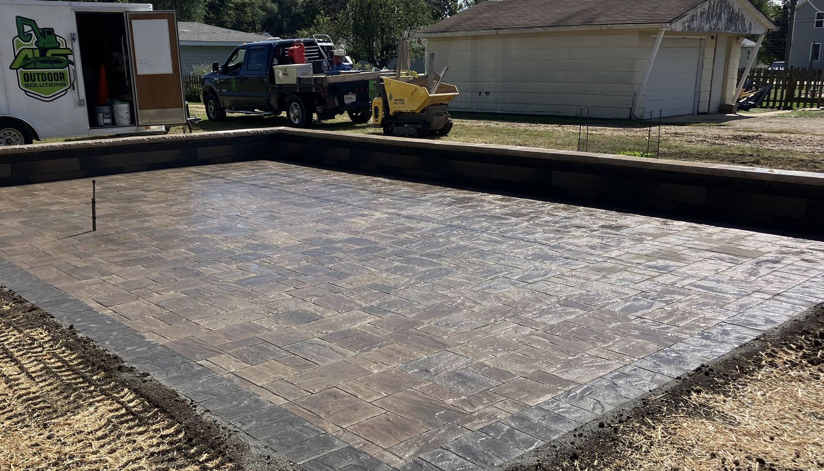 A fire pit is lit up at night on a patio