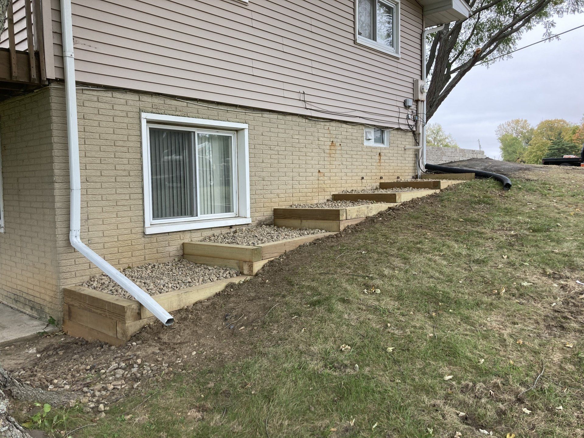 A house with stairs leading up to it and a window on the side of it.