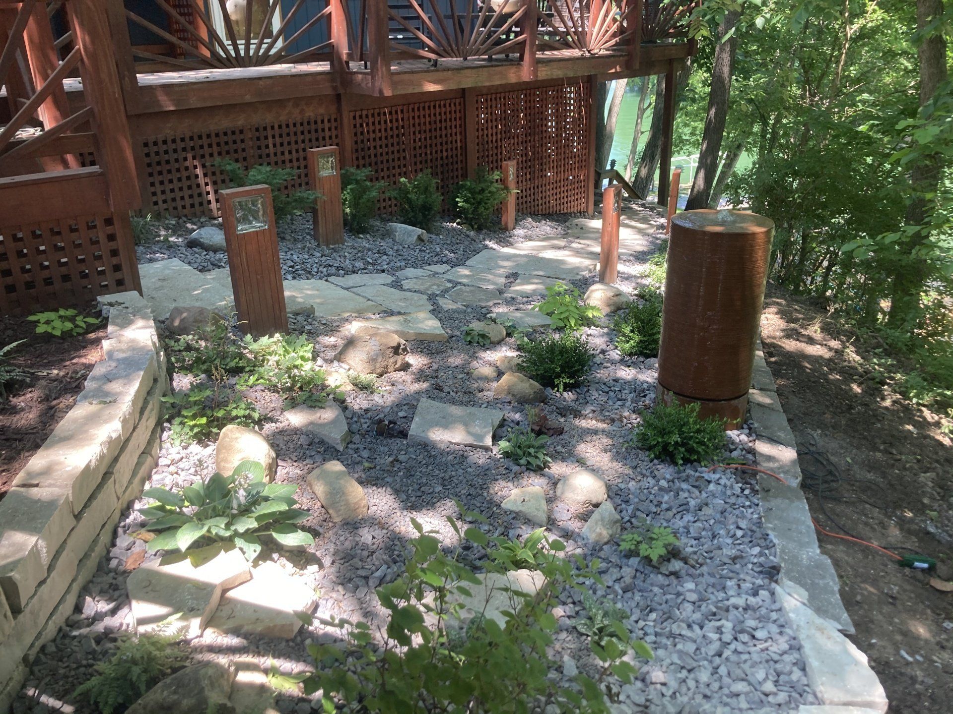 A path leading to a wooden deck in the woods.