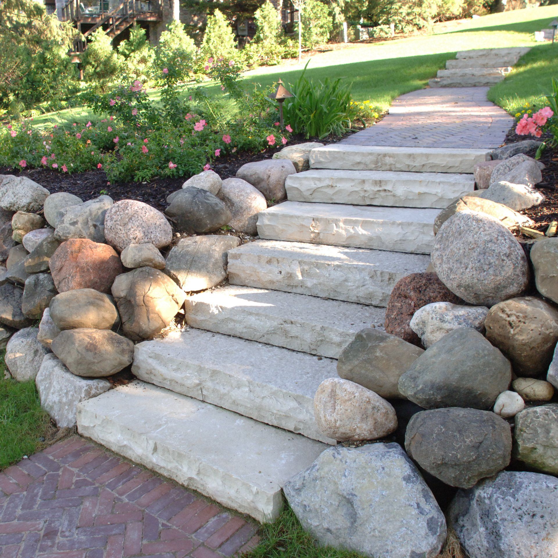 A set of stairs surrounded by rocks in a garden