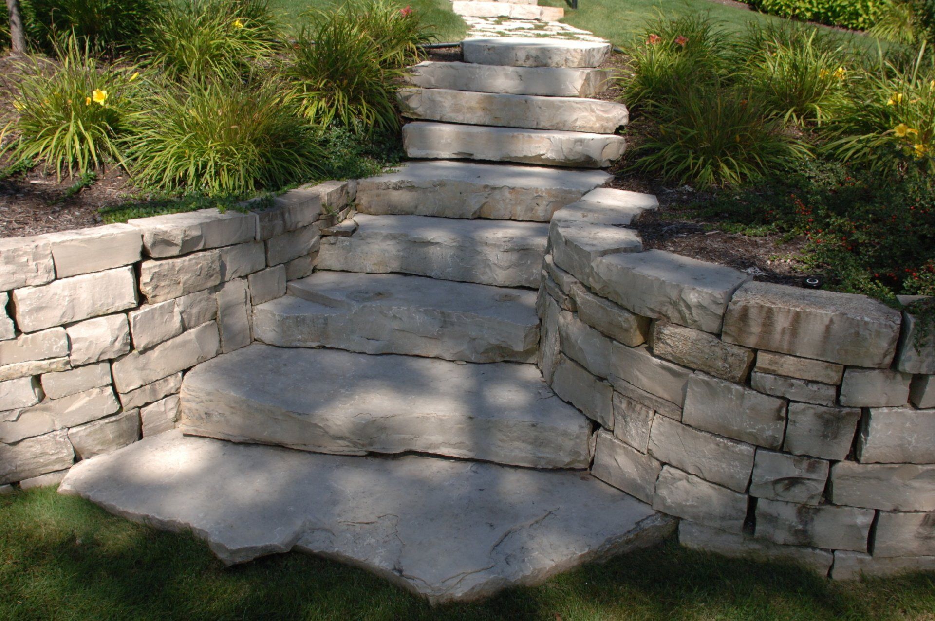 A stone wall with stairs leading up to it