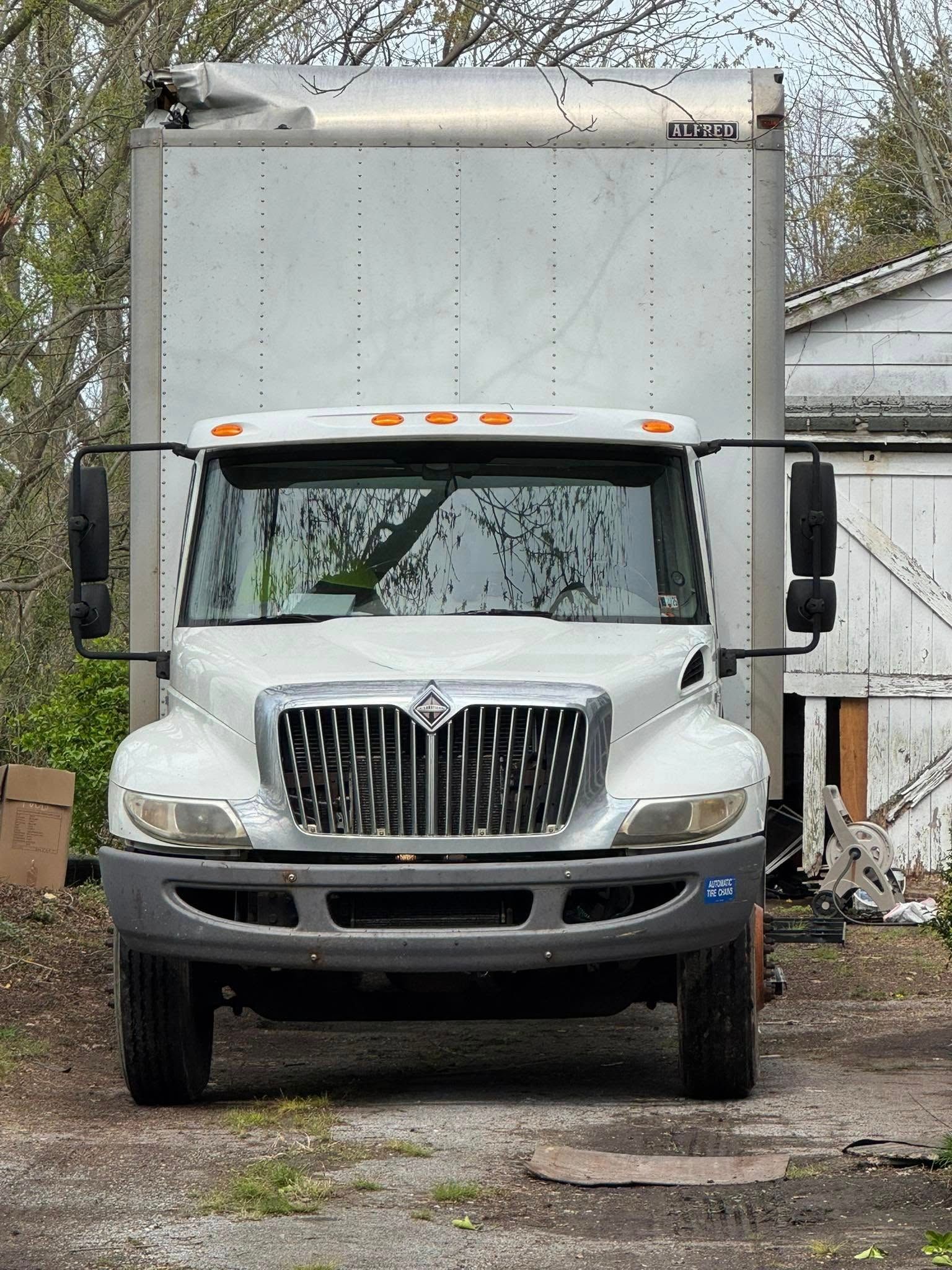 White International box truck parked outdoors.