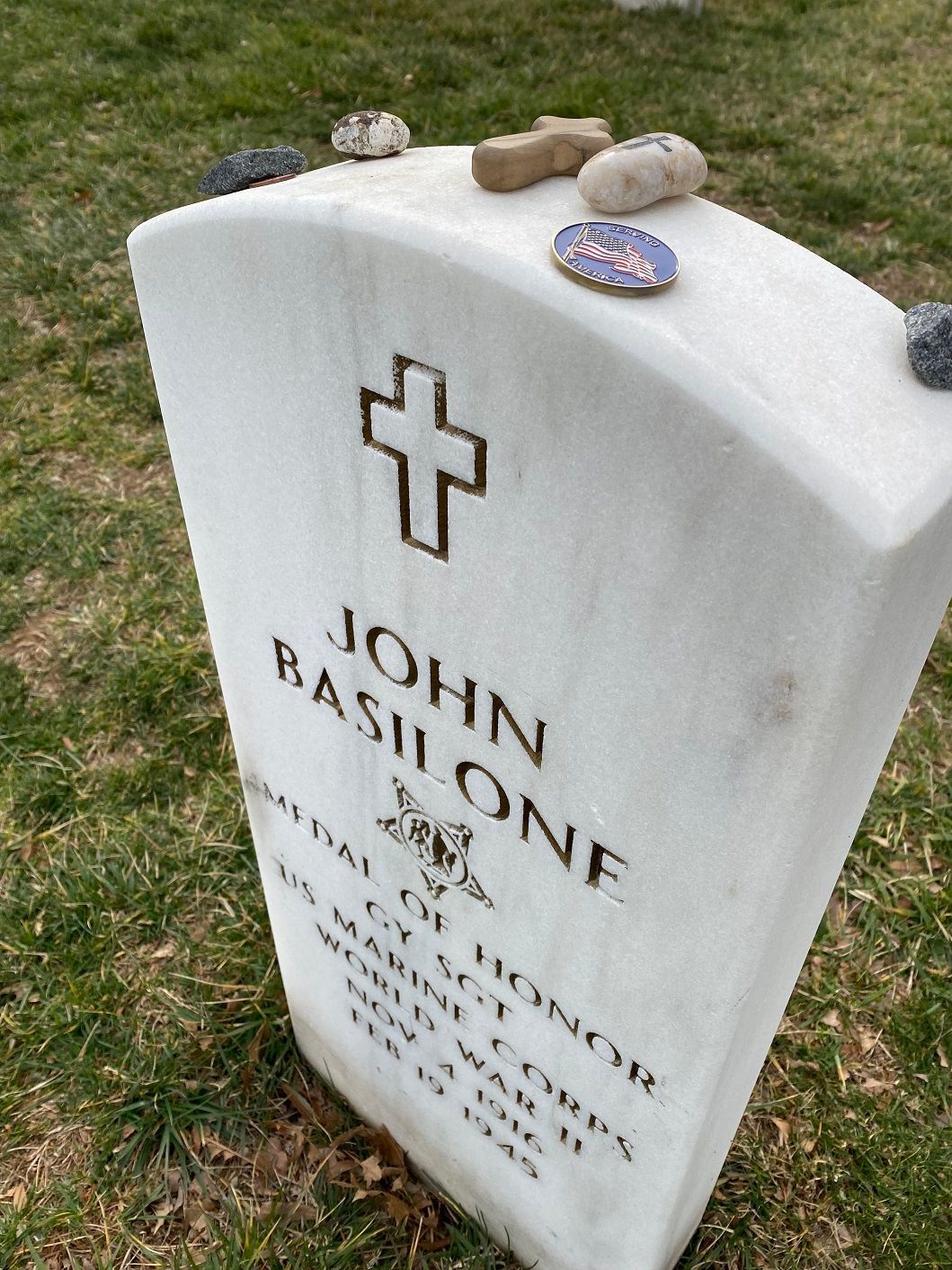 John Basilone's gravestone with a cross and 