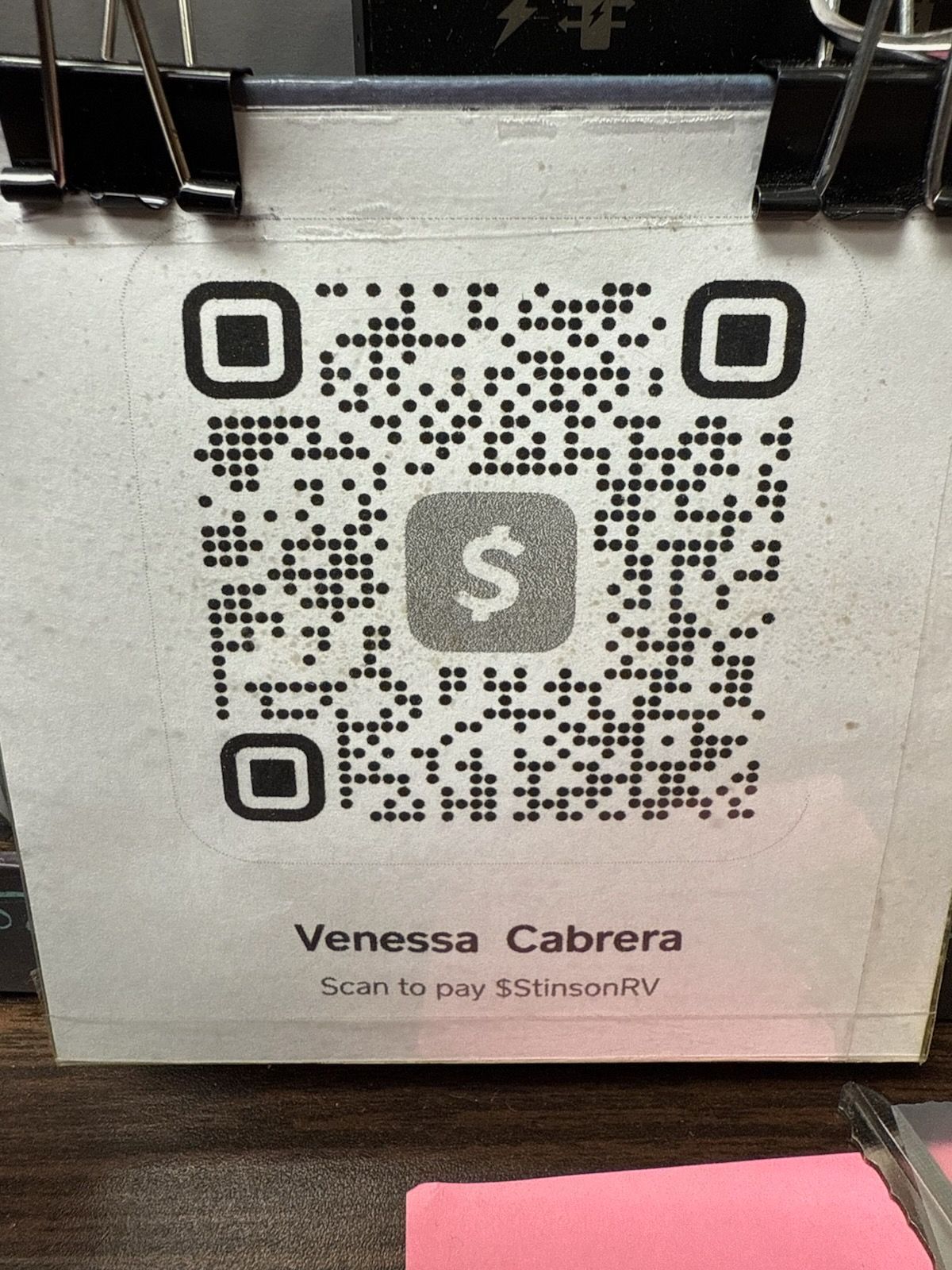 A paper with a Cash App QR code, the name Venessa Cabrera, and the username $silsonRV, held by clips.