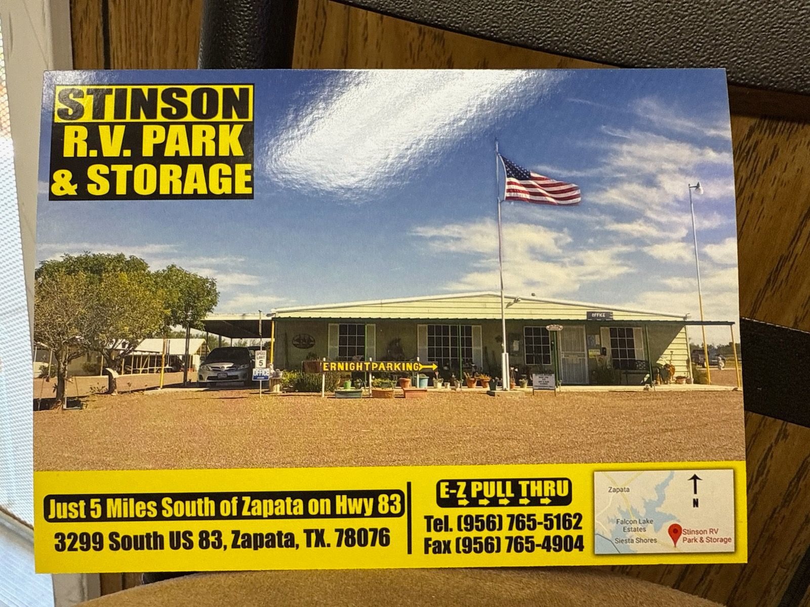 Business card for Stinson RV Park & Storage in Zapata, TX, showing the park's building and American flag.