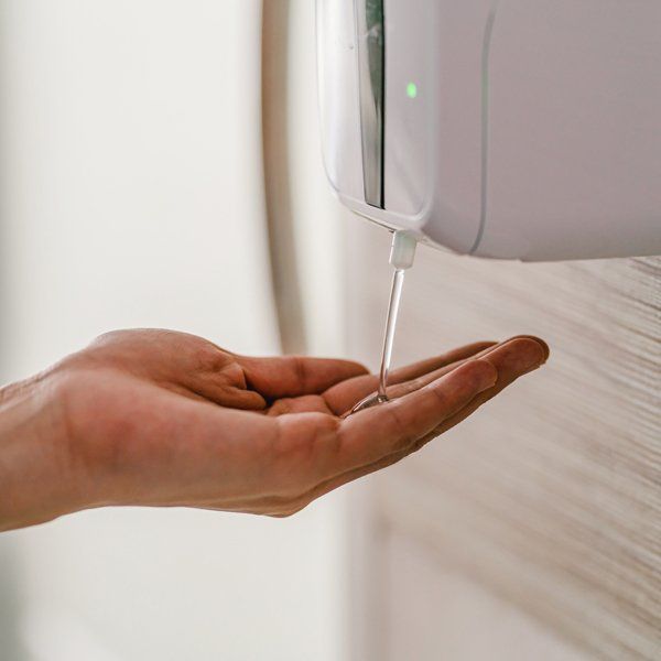 Woman Using Hand Sanitiser — Ballarat East, VIC — RCC Washroom Services