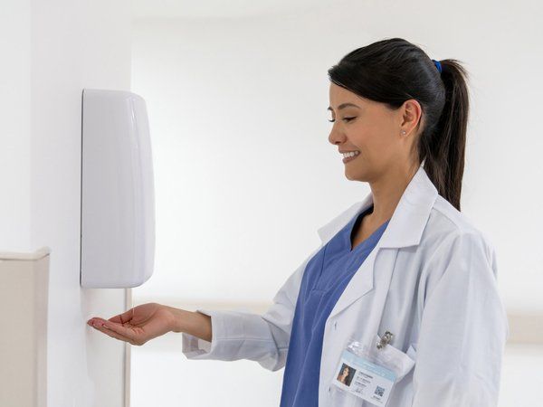 Woman Using Soap Dispenser — Ballarat East, VIC — RCC Washroom Services