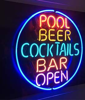 A photograph of a Neon light fixture, on wall, that says Pool, Beer, Cocktails, Bar, Open