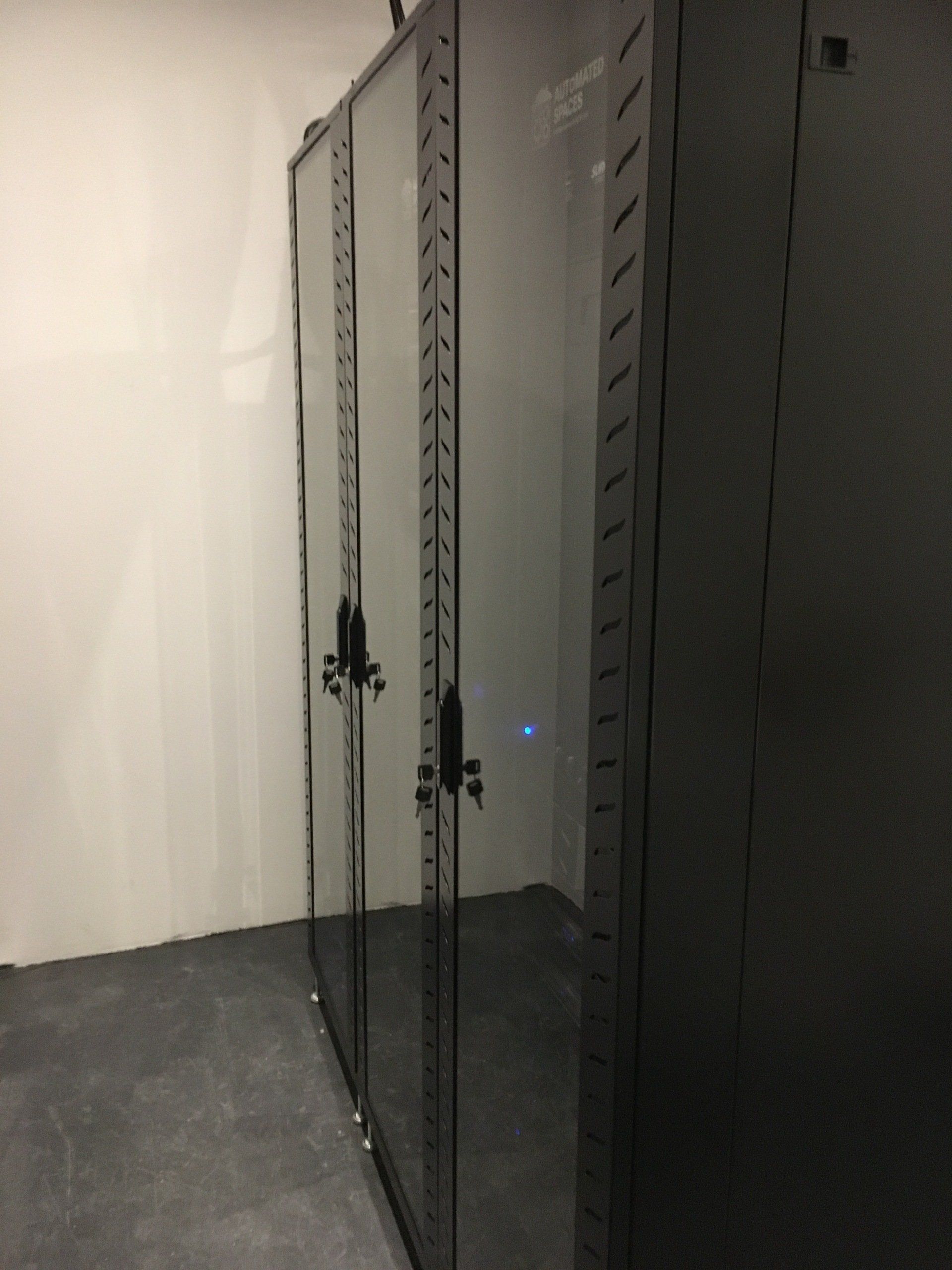 Photograph of front of 3 x 42U server racks