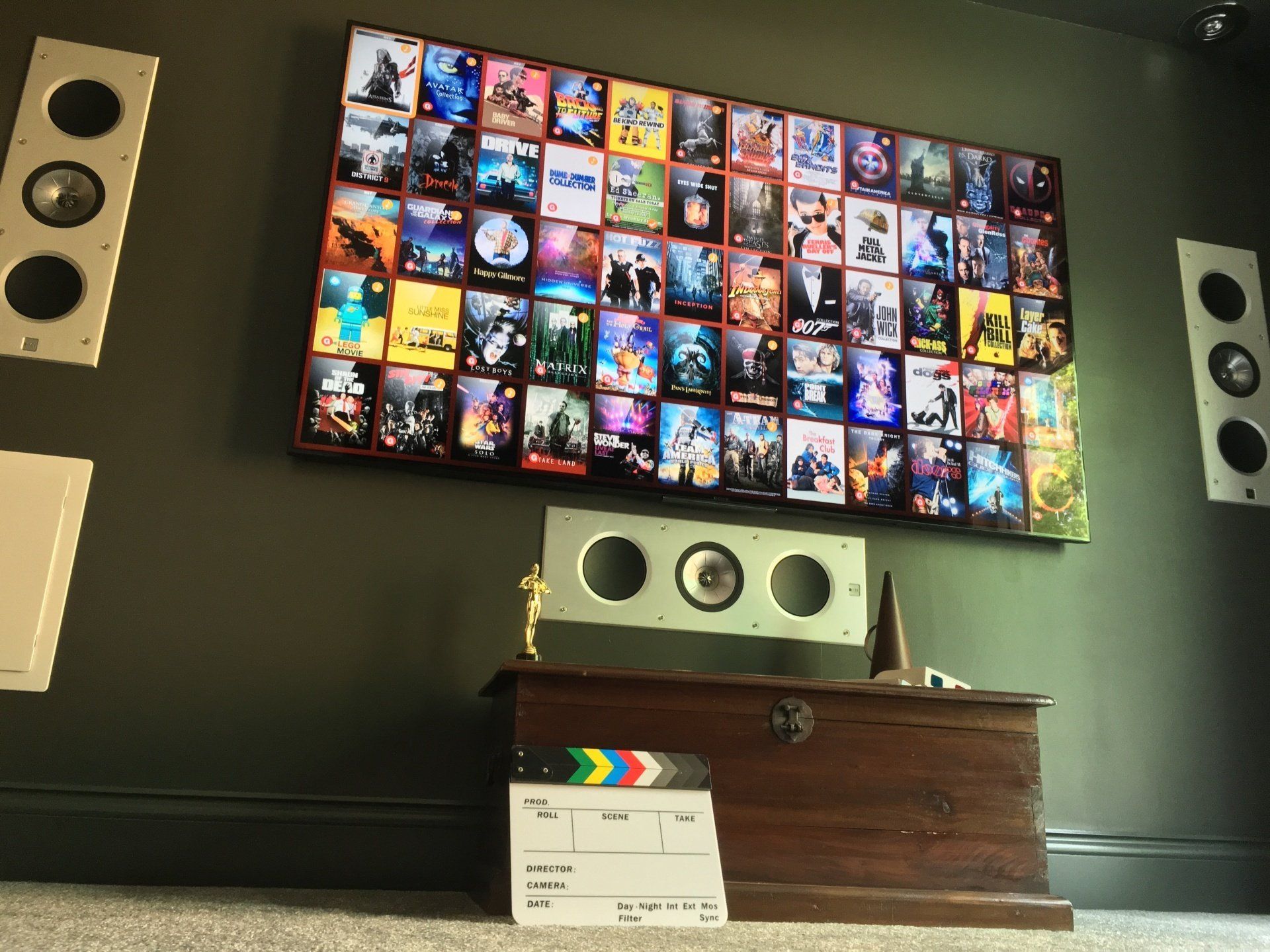 photograph of a TV display and speakers built into wall around TV